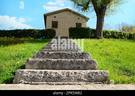 Scale di pietra che conducono a casa all'aperto nelle giornate di sole Foto Stock