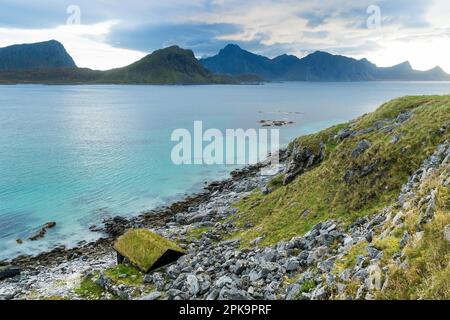 Norvegia, Lofoten, Vestvagoya, sentiero costiero da Haukland Beach a Utttakleiv, capanna di pesca coperta di erba Foto Stock