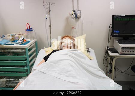 Gli studenti che devono affrontare un'emergenza post-natale seguono le procedure su un manichino. Questo manichino è controllato dagli operatori in una stanza adiacente. Foto Stock