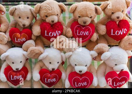 Inghilterra, Londra, Spitalfields, Petticoat Lane Market, esposizione di TeddyBears Holding Love Hearts Foto Stock