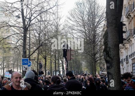 Parigi, Francia. 6th Apr 2023. Michael Bunel / le Pictorium - dimostrazione contro la riforma pensionistica a Parigi - 6/4/2023 - Francia / Parigi - Un protester con cappuccio guarda la folla dal semaforo su cui sta stando. Undicesimo giorno di mobilitazione contro la riforma delle pensioni, l'uso del 49,3 e le politiche del governo di Emmanuel Macron. 6 aprile 2023. Parigi, Francia. Credit: LE PICTORIUM/Alamy Live News Foto Stock