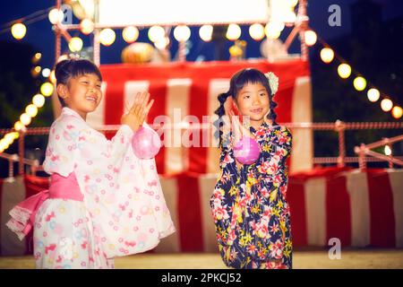 Ragazza in yukata danza bon danza in un festival Foto Stock