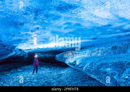 Visita turistica alla grotta di ghiaccio naturale di cristallo nel ghiacciaio di Breiðamerkurjökull / Breidamerkurjokull nel Parco Nazionale di Vatnajökull, Islanda Foto Stock