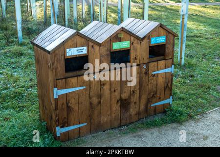 Tre contenitori di rifiuti in legno segregati / compartmentalizzati dal caffè all'aperto Foto Stock