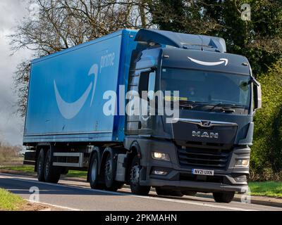 Bicester, Oxon, Regno Unito - Aprile 7th 2023. Amazon prime consegna camion TGX 2021 UOMO che viaggia su una strada di campagna inglese Foto Stock