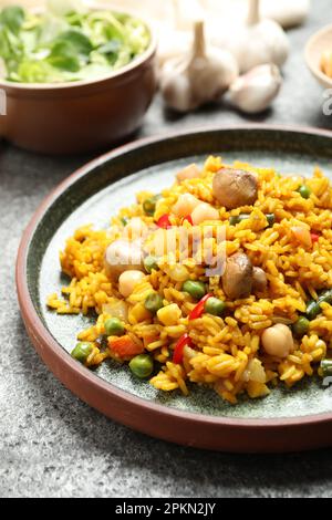 Delizioso pilaf di riso con verdure sul tavolo grigio Foto Stock