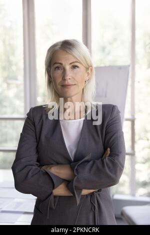 Donna d'affari seria e sicura, insegnante aziendale, capo femmina che guarda la fotocamera Foto Stock