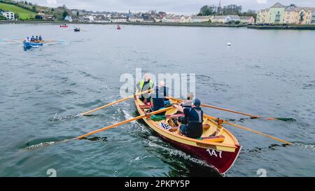 I vogatori su una tradizionale barca a remi in legno prendono parte a una gara mentre entrano nel villaggio di Killyleagh, nell'Irlanda del Nord. Foto Stock