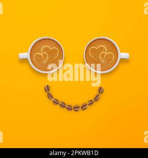 Look sorridente composto da due tazze di caffè e chicchi di caffè su sfondo giallo Foto Stock