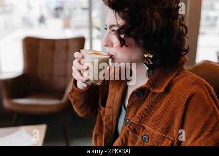 Profilo di bella donna prendendo sorso di latte Foto Stock