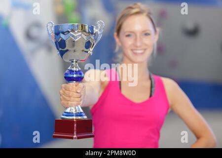 splendida giovane donna bionda in possesso di un trofeo Foto Stock