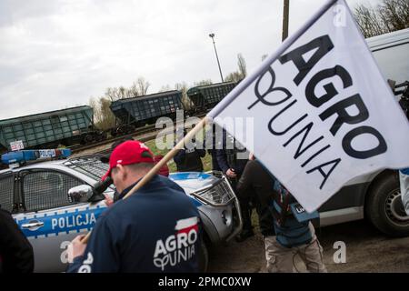 Gli agricoltori che protestano stanno guardando un treno che passa che trasporta grano ucraino alla linea ferroviaria a scartamento largo che attraversa la città di confine di Hrubieszow. La polizia ha impedito l'annunciata protesta di mercoledì mattina degli agricoltori dell'organizzazione AgroUnia (AgroUnion) guidata da Michal Kolodziejczak, che si suppone blocchino la linea ferroviaria a scartamento largo nella città di confine di Hrubieszow, dove il grano proveniente dall'Ucraina entra in Polonia. Come ha detto Michal Kolodziejczak, la protesta è stata denunciata per 7 giorni, ma gli agricoltori sono pronti a prolungarla. (Foto di Attila Husejnow/SOPA Images/Sipa USA) Foto Stock