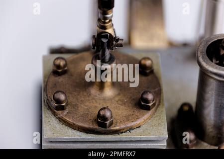 primo piano della costruzione di un motore stirling con tavolo bianco e sfondo bianco Foto Stock