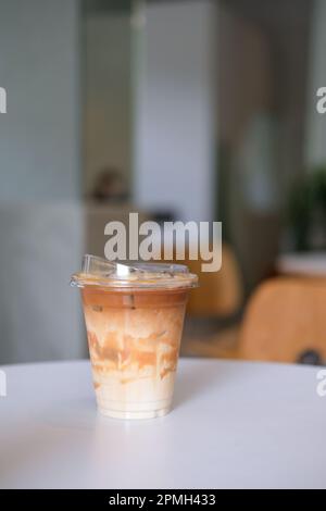 Un bicchiere di caffè ghiacciato sul tavolo Foto Stock