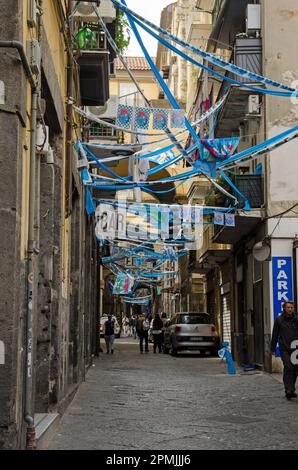 Napoli, Italia - 2 aprile 2023: Bandiere, bunting e streamers si estendono attraverso la via San Giuseppe dei Ruffi nel quartiere Centro storico nel cent Foto Stock