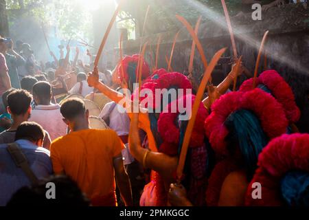 Bangladesh, 13/04/2023, con la fine del mese di Chaitra, l'ultimo dell'anno di Bangla, la comunità indù si riunisce in un festival dedicato al culto di Lord Shiva e Parvati. Il programma è localmente noto come "Lal Kach" (vetro rosso). L'idea centrale di questo programma è che un gruppo di soldati guidati da Shiva appaia sulla terra con una missione: Allontanare le forze del male. Questi soldati, che risplendono nella luce divina di Shiva, marciano verso i templi vicini. Tutto fa parte di una lunga tradizione che risale a centinaia di anni fa. Gli Indù, specialmente i giovani, si dipingono in r Foto Stock