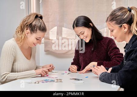 Amici femminili che si divertono mentre fanno le loro unghie insieme. Concetto di manicure e amicizia. Foto Stock