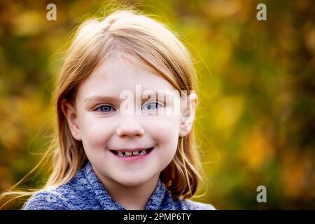 Outdoor portrait of a girl with blue eyes and blond hair in autumn; Edmonton, Alberta, Canada Stock Photo
