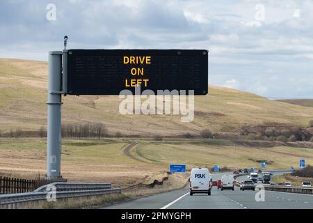 Prosegui sul cartello a sinistra sull'autostrada M74, Scozia, Regno Unito Foto Stock