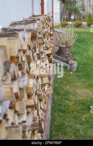 legno tagliato immagazzinato da una casa suburbana Foto Stock