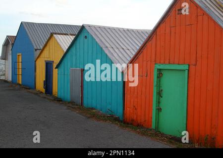 Boathouses di legno usato per immagazzinare le barche sulla corsia Foto Stock