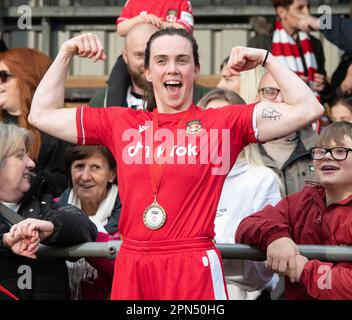 Newtown, Powys Wales, 16th aprile 2023. L'attaccante di Wrexham Rosie Hughes celebra la vittoria del play-off con i tifosi a tempo pieno, durante le donne del club di calcio di Wrexham Association Football Club di Briton Ferry Llansawel Athletic, nel play-off del generale Adran (Credit Image: ©Cody Froggatt Alamy live news) Foto Stock