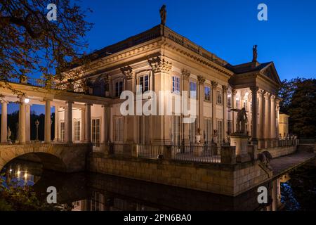 Il Palazzo sull'isola illuminato di notte nel Parco reale Lazienki nella città di Varsavia, Polonia. Residenza estiva del re Stanisław agosto Poniatowsk Foto Stock