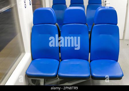 Interno vuoto del treno. Sedili blu Foto Stock