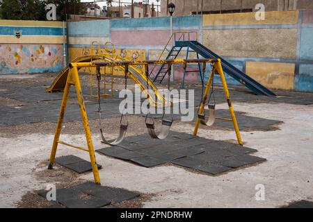 scendono le altalene sul parco giochi per bambini Foto Stock