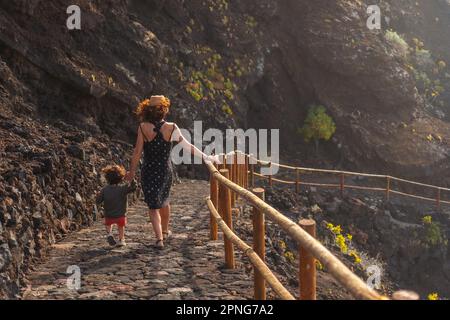 Tramonto sull'isola di El Hierro. Isole Canarie, madre e figlio sulla strada verso Charco Azul Foto Stock