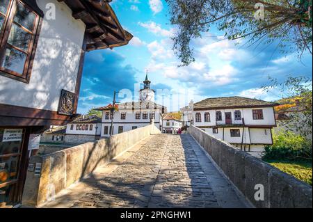 TRYAVNA, BULGARIA. La torre dell'orologio e il ponte in pietra nel centro storico nel complesso architettonico tradizionale. Rinascita architettura bulgara Foto Stock