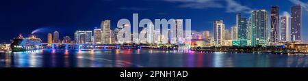 Skyline panoramico di Miami Downtown all'alba, crociera illuminata Virgin Voyage con LUCE AHOY in blu e rosso Floridas East Coast Miami florid Foto Stock