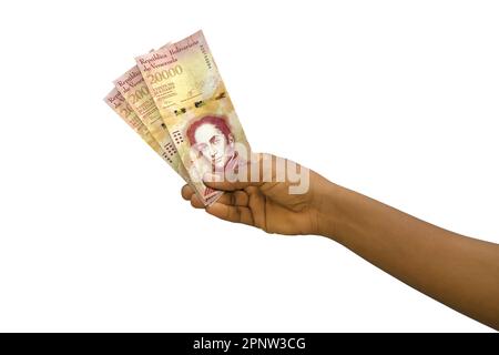 Fair Hand holding 3D rese note bolivar venezuelane isolate su sfondo bianco Foto Stock