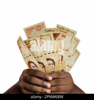 Lancette nere con 3D note bolivar venezuelane. Primo piano delle mani che detengono banconote venezuelane Foto Stock