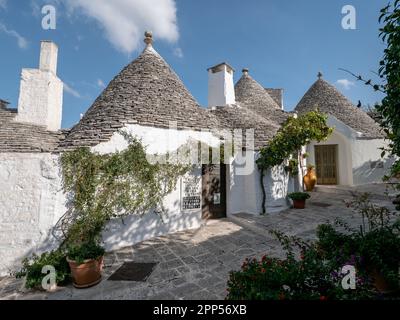 ALBEROBELLO, ITALIA - 29 OTTOBRE 2021: Case bianche Trulli ad Alberobello, Italia in una bella giornata di sole Foto Stock