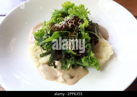 Couscous con salsa su piatto bianco nel ristorante Foto Stock