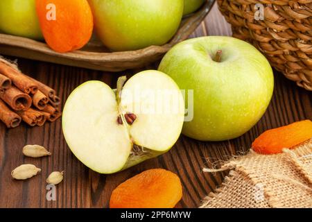 mela granny smith tagliata su sfondo di legno Foto Stock