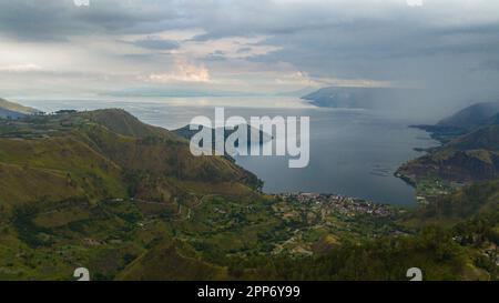 Bellissimo lago Toba circondato da montagne con foresta tropicale. Sumatra, Indonesia. Foto Stock