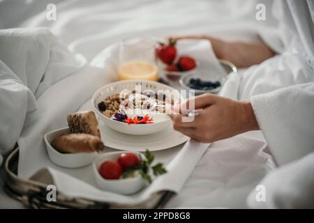 Donna che ha muesli a colazione a casa Foto Stock