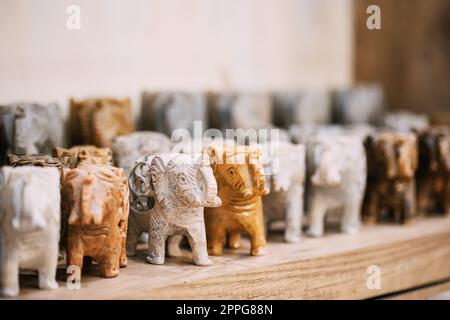 Goa, India. Souvenir dell'elefante di pietra sulla mensola in negozio. Merci per turisti Foto Stock