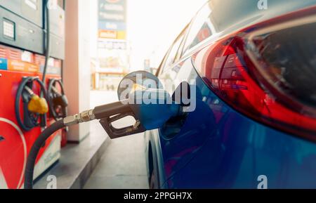 Rifornimento di auto presso la stazione di servizio. Rifornire con benzina. Pompa benzina ugello di riempimento carburante nel serbatoio del carburante dell'auto presso la stazione di servizio. Industria e servizi benzina. Prezzo della benzina e concetto di crisi petrolifera. Foto Stock