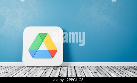 Logo dell'app Google Drive su pavimento in legno contro muro Foto Stock