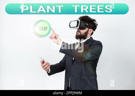 Scrittura a mano di testo piante alberi. Parola scritta su processo di piantare un albero per la coltivazione di terra e la silvicoltura Foto Stock