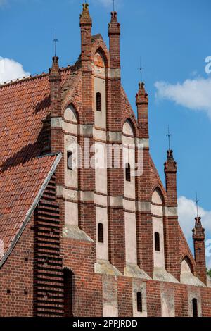 Gothic St Chiesa di Lawrence accanto al castello di Malbork del XIII secolo, fortezza teutonica medievale sul fiume Nogat, Malbork, Polonia Foto Stock