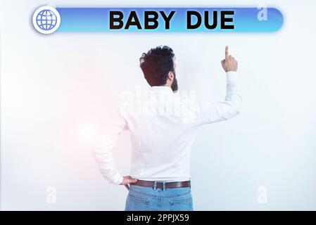 Didascalia di testo che presenta Baby due. Concetto che significa circa nascere sotto impegno quanto tempo previsto per essere pronto Foto Stock