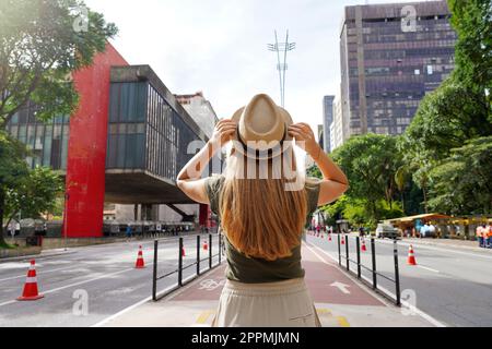 Ragazza viaggiatore in visita a San Paolo, Brasile. Vista posteriore della giovane bella donna turistica sulla Paulista Avenue, Sao Paulo, Brasile. Foto Stock