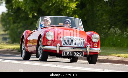 Bicester, Oxon, Regno Unito - Maggio 29th 2022. 1959 rosso 1588 cc MGA classica sportiva britannica che guida su una strada di campagna Foto Stock