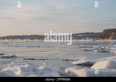 Baia di ghiaccio marino con Abashiri città sullo sfondo Foto Stock