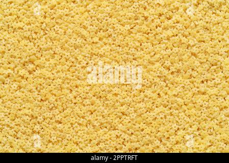Piccola pasta stellina a forma di stella per la consistenza o lo sfondo della zuppa. Foto Stock