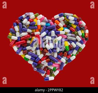 Pillole Capsule Medicina organizzato a forma di cuore Foto Stock